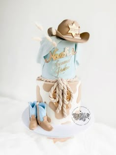 a birthday cake with cowboy hats and boots on top