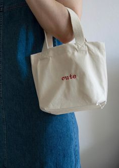 This small, personalized canvas bag is perfect for many occasions. Whether as a handbag for on-the-go, for quick errands, as a sustainable gift bag, or as a snack bag for kindergarten - it's practical and looks great. You can customize the small bag with embroidery however you like. Add a name, a special word, or even a small symbol of your choice. The bag is made of durable, 340 gsm organic cotton canvas. It features woven handles with a length of 34 cm for easy carrying. With a capacity of 4 l Everyday Bags With Embroidered Logo And Double Handle, Embroidered Canvas Bags For Daily Use, Trendy Shoulder Bag With Embroidered Logo For Daily Use, Beige Bags With Embroidered Logo For Daily Use, Beige Shoulder Bag With Embroidered Logo For Everyday Use, Daily Use Embroidered Canvas Bags, Summer Shoulder Bag With Embroidered Logo For Daily Use, Embroidered Canvas Bags For Everyday Use, Embroidered Canvas Everyday Bag