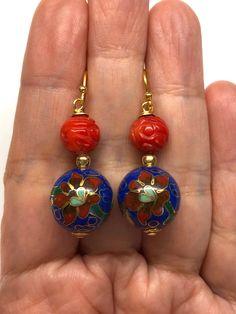 Vintage Chinese Floral Cloisonné Bead from the 60's and Carved Red Sea Bamboo Bead Earrings. Cloisonné is the technique of creating designs on metal vessels with coloured enamel placed within enclosures made of copper or bronze wires. The beads have a beautiful floral pattern with blue, red, green, brown, white and pink enamel. Paired with carved red sea bamboo beads, these are very beautiful and colourful earrings! - Made with Cloisonné Beads from the 60's, Red Sea Bamboo Beads and Gold-plated Unique Red Jewelry For Celebration, Handmade Red Enamel Jewelry, Red Enamel Round Earrings, Red Round Enamel Earrings, Traditional Red Enamel Jewelry, Traditional Red Beaded Earrings With Large Beads, Nickel-free Red Beaded Round Earrings, Festive Earrings With Colorful Beads, Unique Round Beads Earrings For Festivals