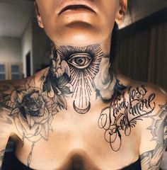 a woman with tattoos on her chest has an all seeing eye tattooed on her neck