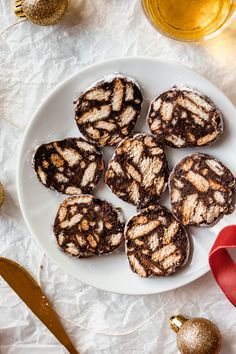 chocolate cookies on a white plate with text overlay that reads no bake, no eggs russian chocolate salami