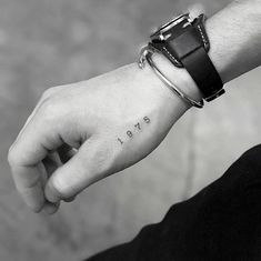 a person's wrist with the word hope tattooed on it, in black and white