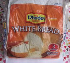 a bag of white bread sitting on top of a table