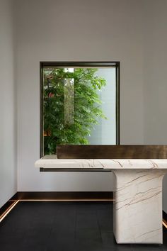 a white marble table in front of a window