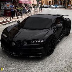 a black bugatti is parked on the street