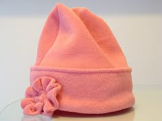 a pink hat with a flower on it