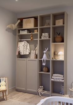 a baby's room with shelves and toys