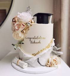 there is a wedding cake decorated with flowers on the top and congratulations written on the side