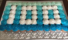 a cake that is decorated with blue and white frosting on top of a table