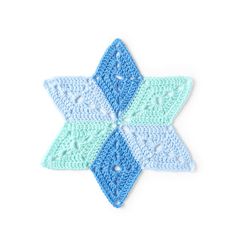 a crocheted blue and green star ornament on a white background photo