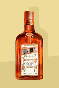 a bottle of cointreau orange liqueur sitting on a yellow background