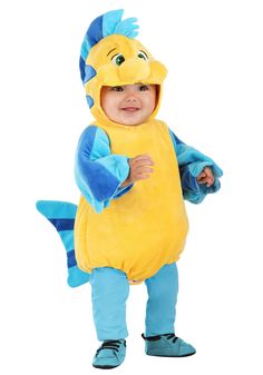 a baby in a yellow fish costume standing with his hands on his hips and looking at the camera