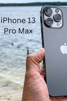 someone holding up an iphone 13 pro max in front of the ocean with text overlay