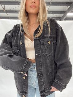 Meet your NEW go-to denim jacket! Our Denim Oversized Claudia Jacket is back in BLACK and we are obsessed! Throw on this staff favorite with just about anything for a trendy, cool girl vibe! Oversized fit. Sizing runs true. Morgan F. is shown wearing a size small Call/text Lane 201 for styling tips and questions at (260) 444-9147! Oversized Dark Denim Jacket Outfit, Outfits With Oversized Jackets, Black Denim Jacket Outfit Aesthetic, Oversized Black Jean Jacket Outfits, How To Style Black Denim Jacket, Oversized Black Denim Jacket Outfit, Black Jeans Jacket Outfit, Demin Jacket Outfits, Outfit Jeans Jacket