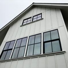 the side of a white building with several windows