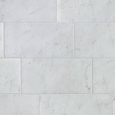 a white marble tile wall that looks like it has been cleaned