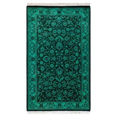 a green rug with an intricate design on it