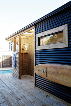 an instagramted photo of a surfboard on the deck of a tiny house