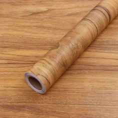 a roll of wood paper on top of a wooden table