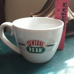 a white coffee cup sitting on top of a table