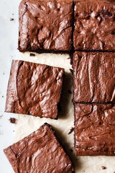 chocolate brownies cut into squares on a white surface