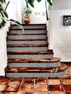 the stairs are decorated with black and white tiles