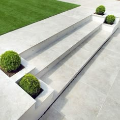 modern concrete steps with planters and grass in the backgroung area, leading to an open lawn