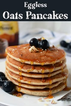 a stack of pancakes with blueberries and syrup on top