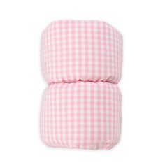 two pink and white checkered pillows sitting next to each other on a white background