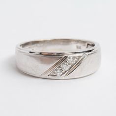 a white gold wedding ring with diamonds on the side, set in 18k white gold