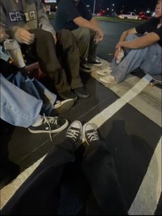 people sitting on the ground with their feet up