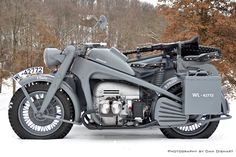 a motorcycle is parked in the snow near trees