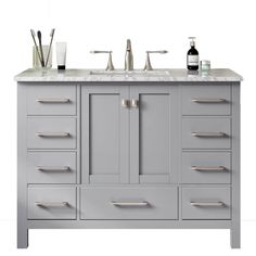 a gray bathroom vanity with two sinks and soap dispensers