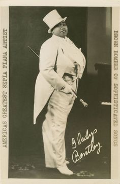 an old black and white photo of a man in a top hat, suit and cane