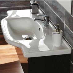 a bathroom sink with soap dispenser and toothbrush holder