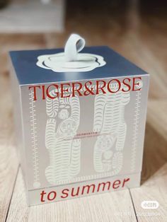 a tiger and rose box sitting on top of a wooden floor