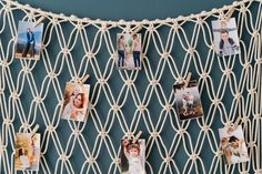 there are many pictures pinned to the wall with rope around them and hanging on hooks