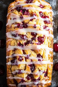 a loaf of cranberry bread with icing drizzled on top