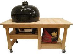 a big green egg sitting on top of a wooden table