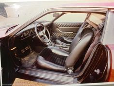 the interior of a sports car with its door open