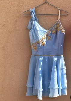 a light blue dress hanging on a wall