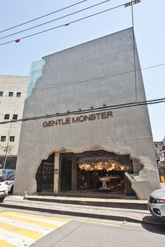 a car is parked in front of a building that has been built into the side of it