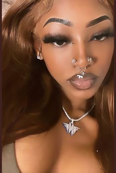 a woman with piercings on her nose and chest