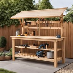 a wooden work bench with tools on it in front of a fenced backyard area