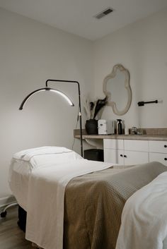 a bedroom with a bed, desk and mirror