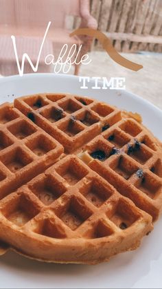 two waffles on a white plate with the words waffle time over it