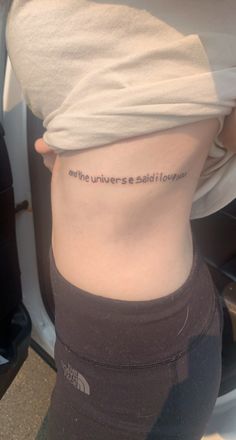 the back of a woman's stomach with an inscription on it that reads, and the