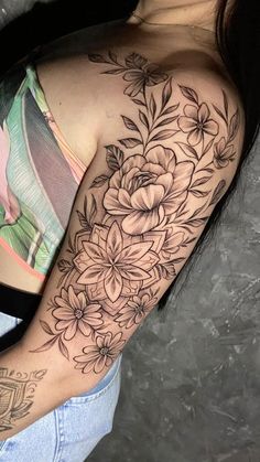 a woman with a flower tattoo on her arm