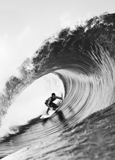 a man riding a wave on top of a surfboard