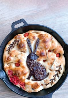 a cast iron skillet filled with food on top of a wooden table